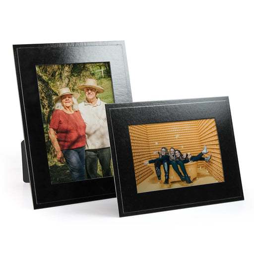 Glossy black cardboard picture frames in vertical and horizontal format. Frames has a subtle leatherette texture.