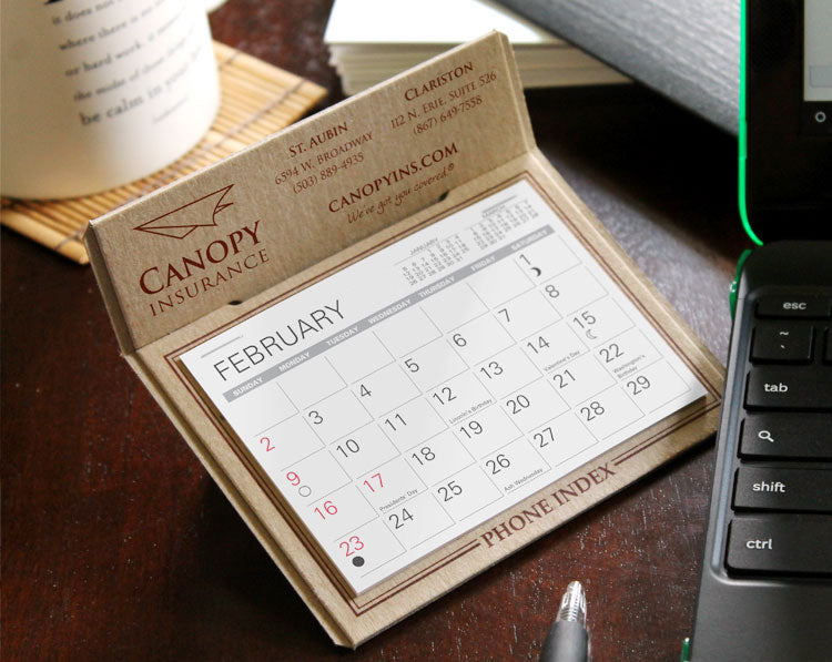 Brown kraft desk calendar with insurance company logo imprinted in maroon foil.