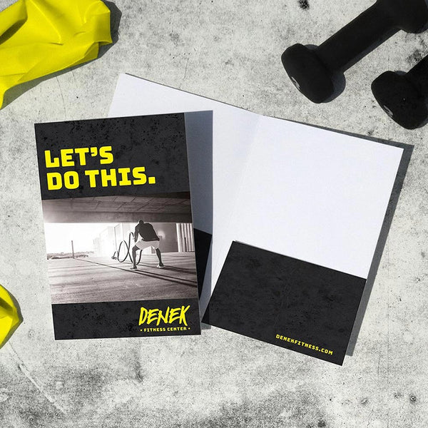 Black and yellow pocket folder for a fitness center welcome packet