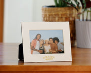 Personalized cream mat board frame with gold foil logo imprint.