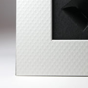 Golf ball texture detail with beveled edge.