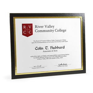 Glossy black horizontal frame has a gold foil border around the window. It's framing a community college diploma.