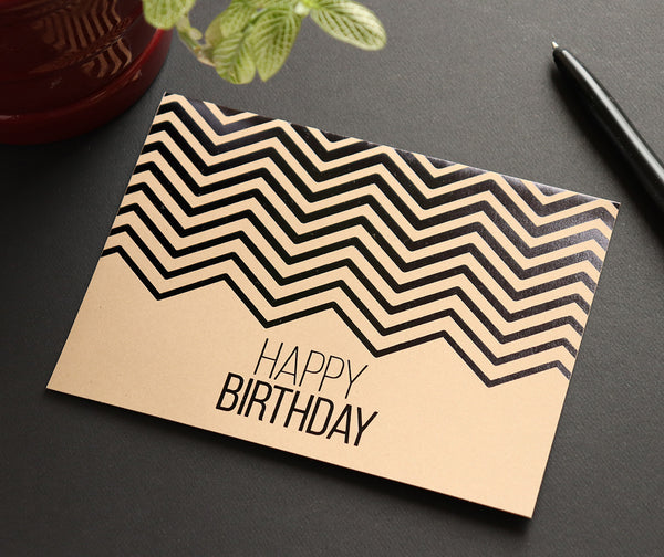 Kraft business birthday card on a desk
