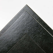 Subtle leatherette texture on black cardboard frame