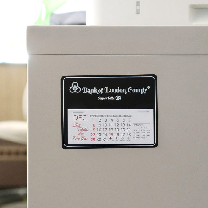 Black calendar with bank logo sticks on an office cabinet