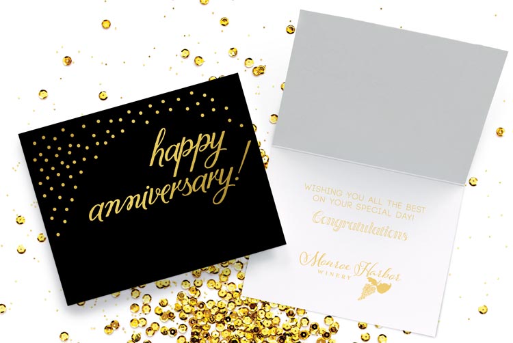 A black anniversary greeting card with gold boil bubble design and stock sentiment and logo foil stamped inside the card.