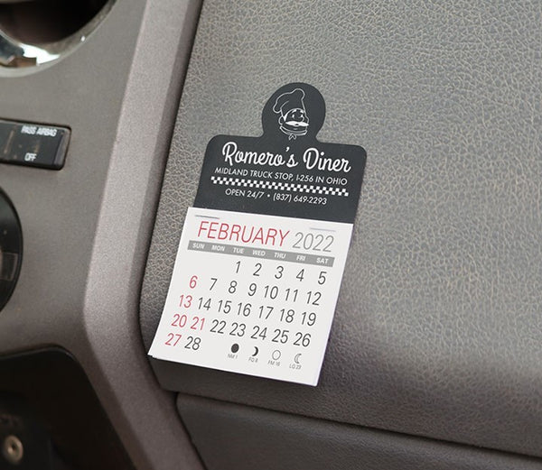 Black dashboard calendar advertising a diner at a truck stop