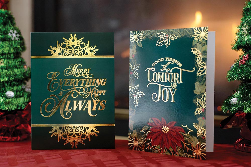 Two green Christmas cards with decorative gold foil imprint and embossed designs.
