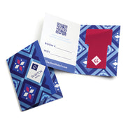 Hotel room key held in place by two slits on a blue geometric designed card folder for a hotel
