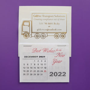 White truck calendar with gold foil imprint of a truck design and contact info for a transportation service.