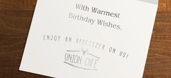 Silver foil stamped birthday sentiment and cafe logo inside a greeting card