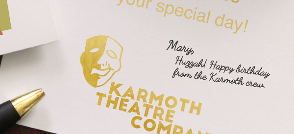 A handwritten birthday message inside a greeting card that has a gold foil sentiment and theatre logo imprint.