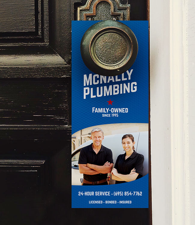 Blue door hanger hangs on a knob. Hanger shows a picture of two people leaning against a service van with their logo and company info printed above and below the photo.