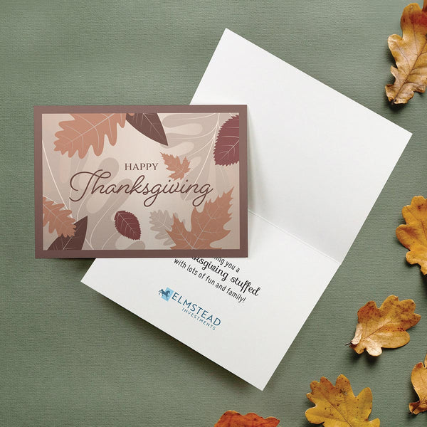 The greeting card lies closed on an open card, showing a sentiment and blue company logo.