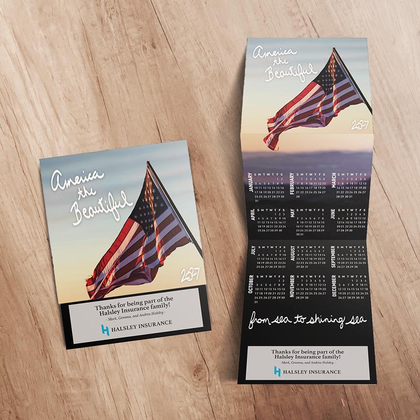 USA-themed tri-fold calendar with insurance company logo and message
