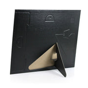 Back of frame with pop-out desk easels and wall-hanging tabs.
