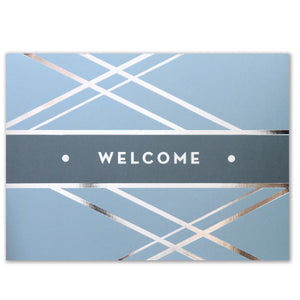 Light blue welcome card with criss-cross silver foil design